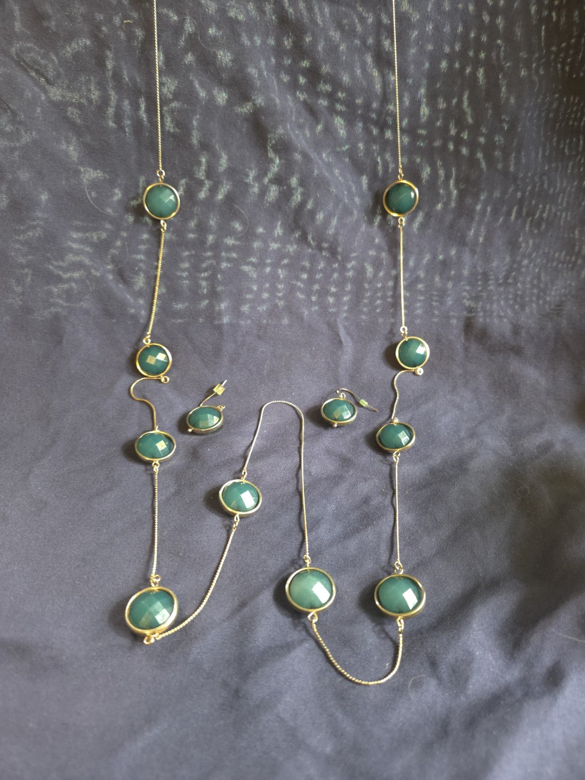 bezel-set green gemstone long chain necklace and earrings featuring faceted...