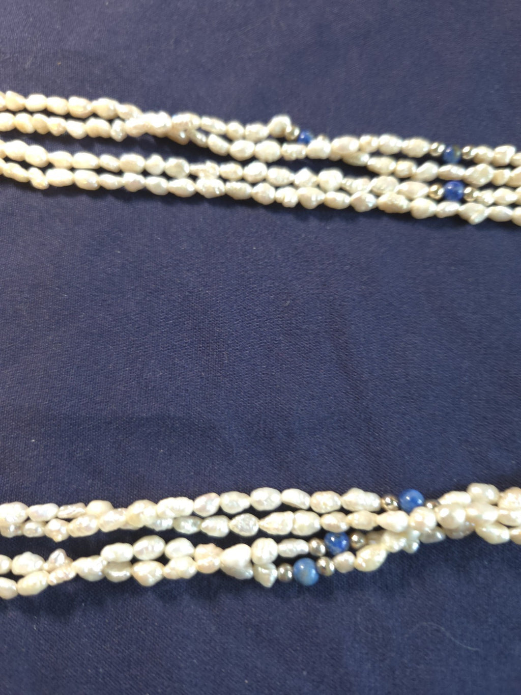 Vintage multi-strand rice pearl necklace featuring blue lapis lazuli accents