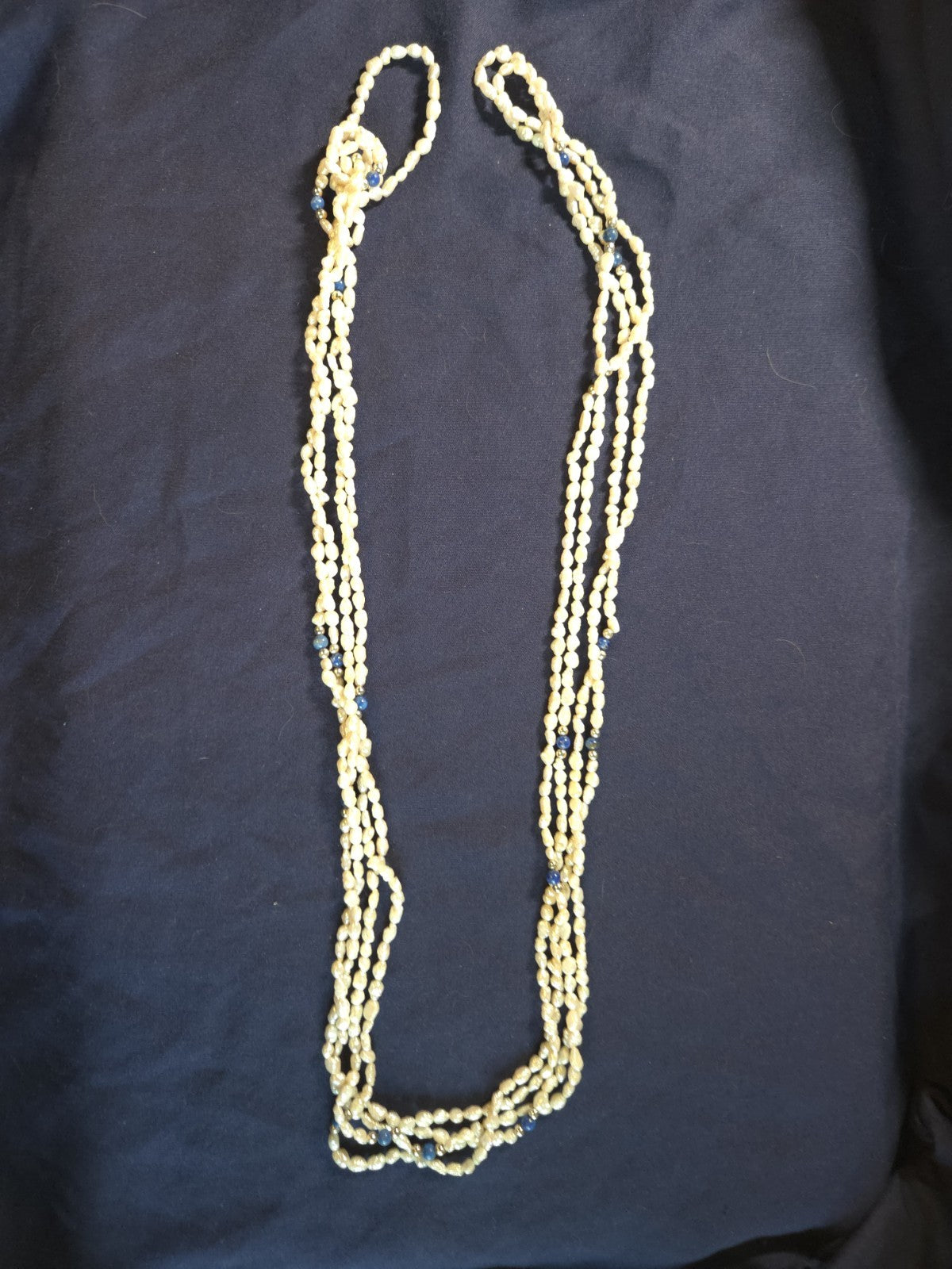 Vintage multi-strand rice pearl necklace featuring blue lapis lazuli accents