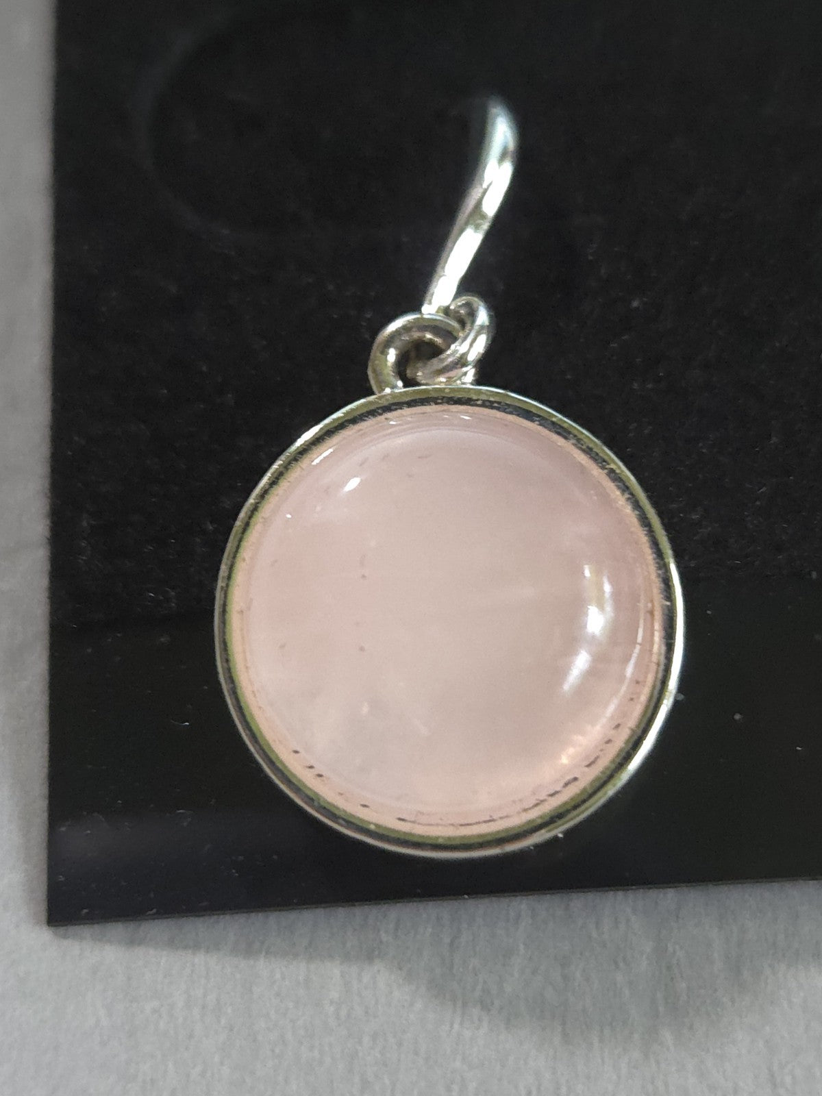 silver-tone drop earrings featuring polished, round pink rose quartz cabochons