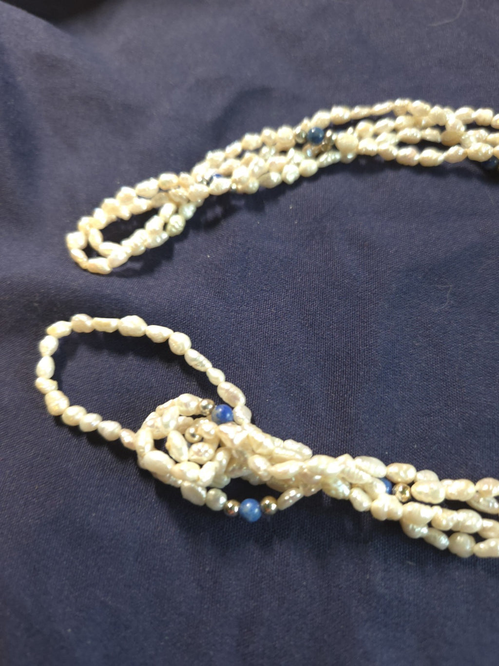 Vintage multi-strand rice pearl necklace featuring blue lapis lazuli accents