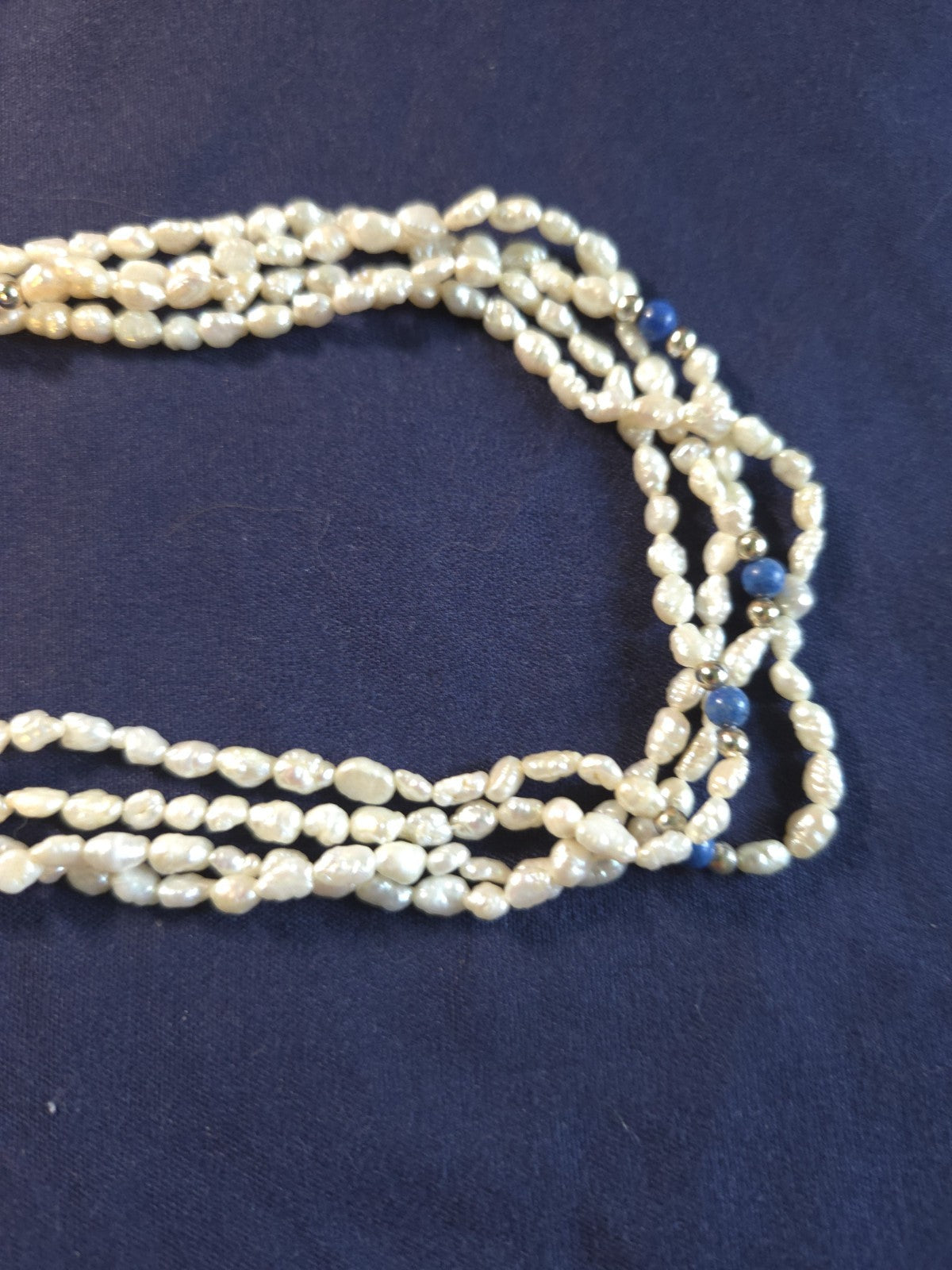 Vintage multi-strand rice pearl necklace featuring blue lapis lazuli accents