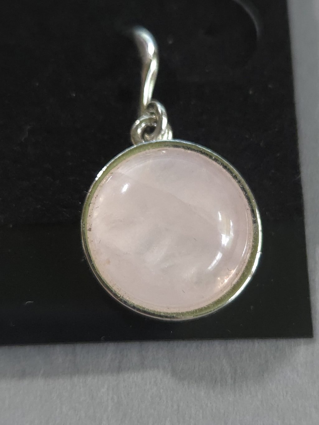 silver-tone drop earrings featuring polished, round pink rose quartz cabochons