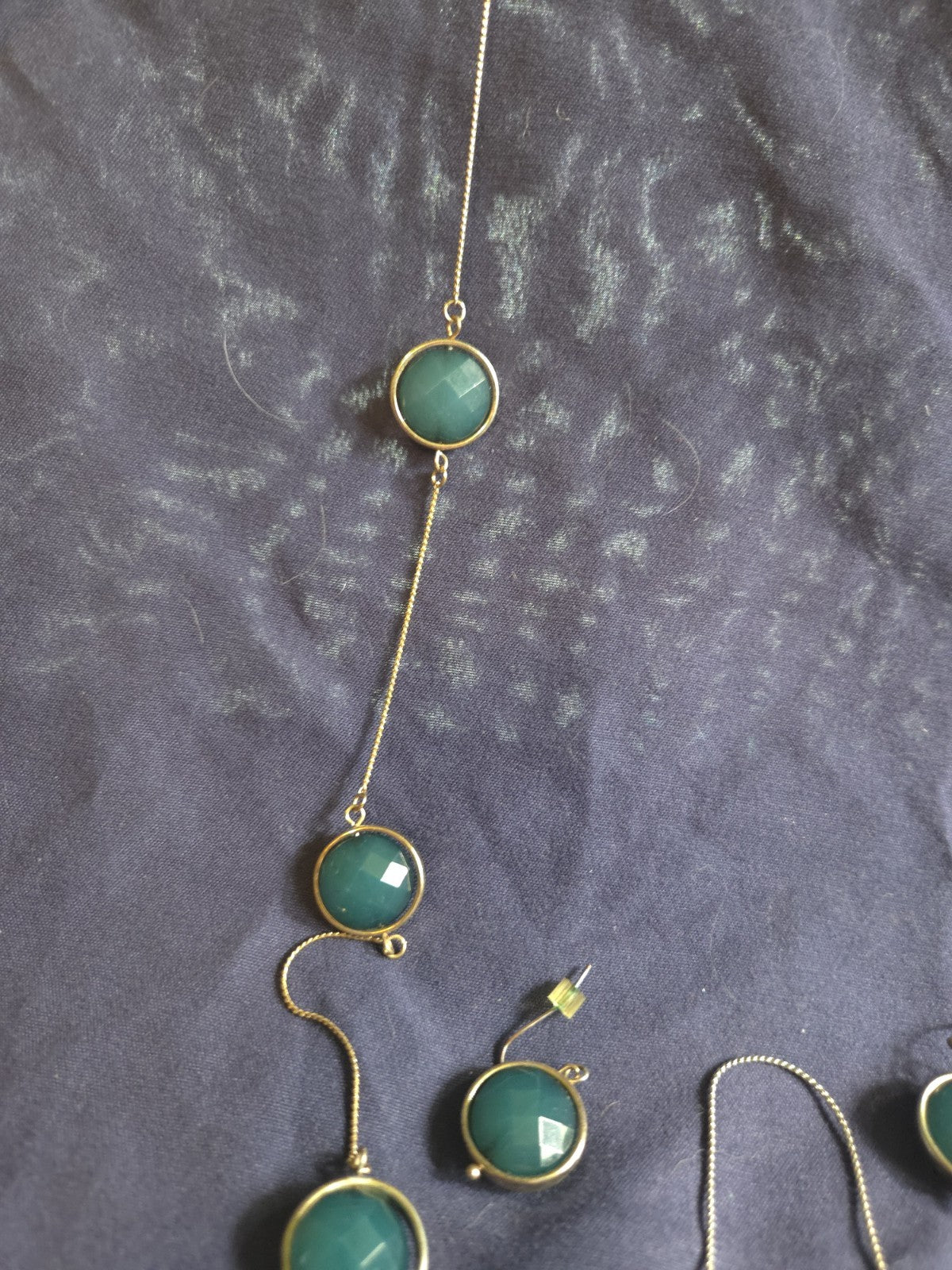 bezel-set green gemstone long chain necklace and earrings featuring faceted...