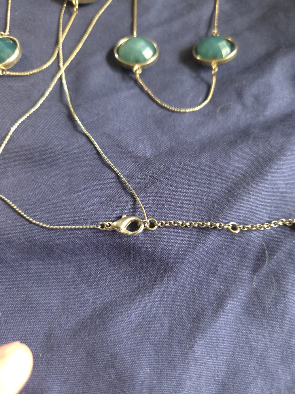 bezel-set green gemstone long chain necklace and earrings featuring faceted...