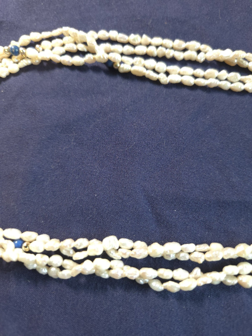 Vintage multi-strand rice pearl necklace featuring blue lapis lazuli accents
