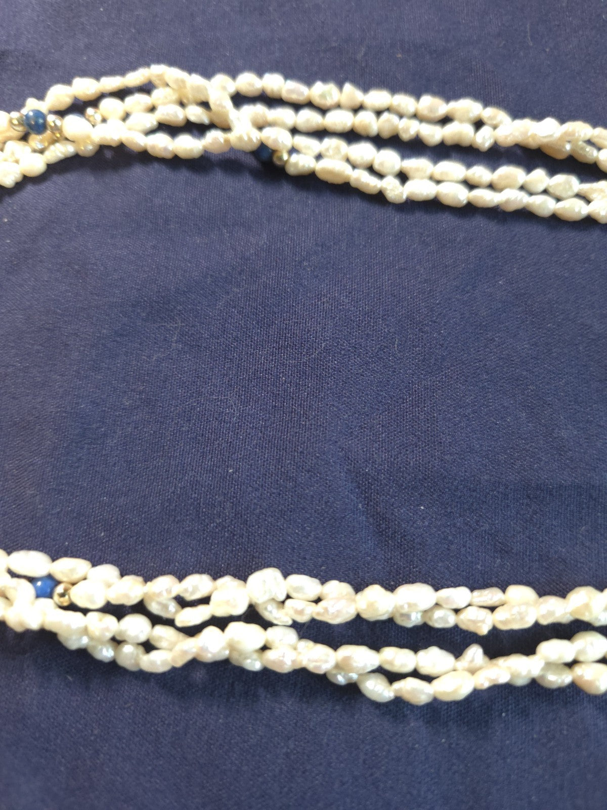 Vintage multi-strand rice pearl necklace featuring blue lapis lazuli accents