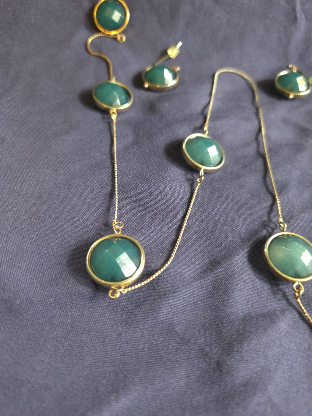 bezel-set green gemstone long chain necklace and earrings featuring faceted...