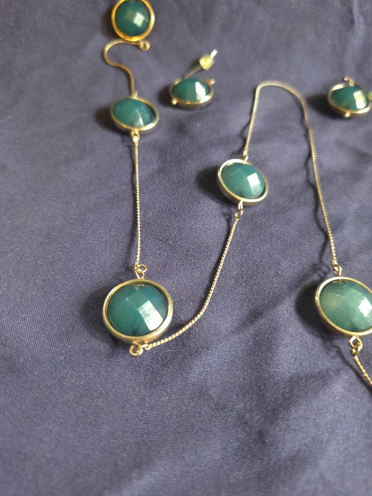 bezel-set green gemstone long chain necklace and earrings featuring faceted...