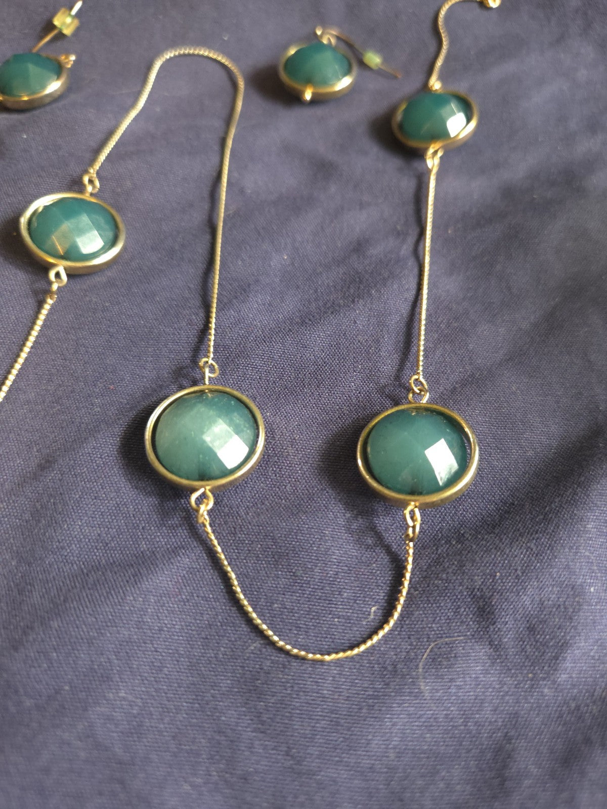 bezel-set green gemstone long chain necklace and earrings featuring faceted...