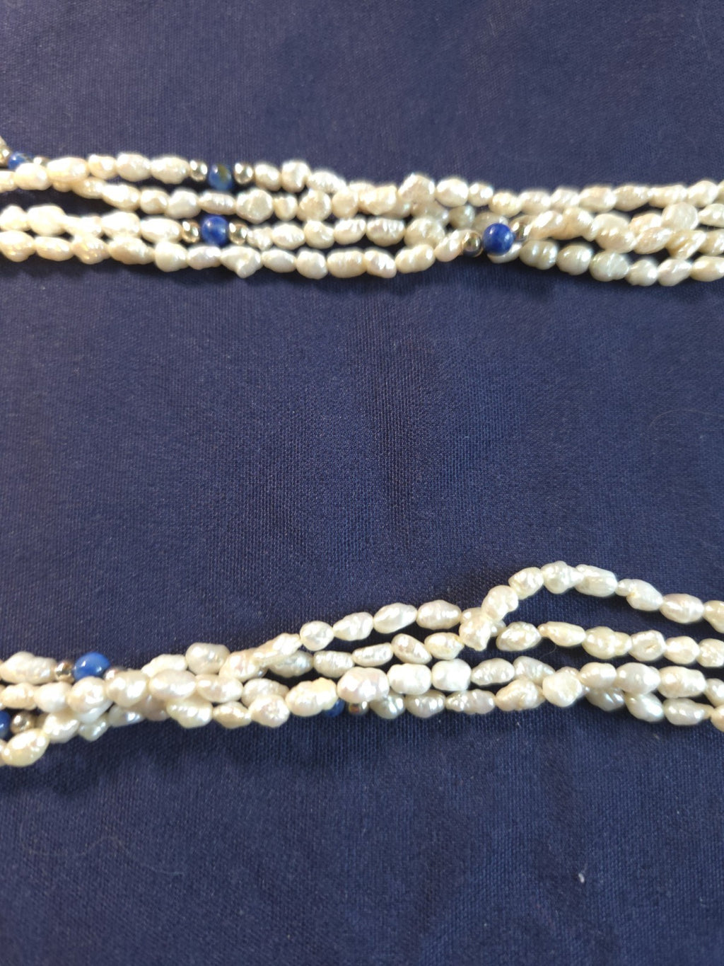 Vintage multi-strand rice pearl necklace featuring blue lapis lazuli accents