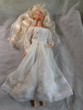 Mattel Barbie doll wearing a white pleated vintage wedding dress