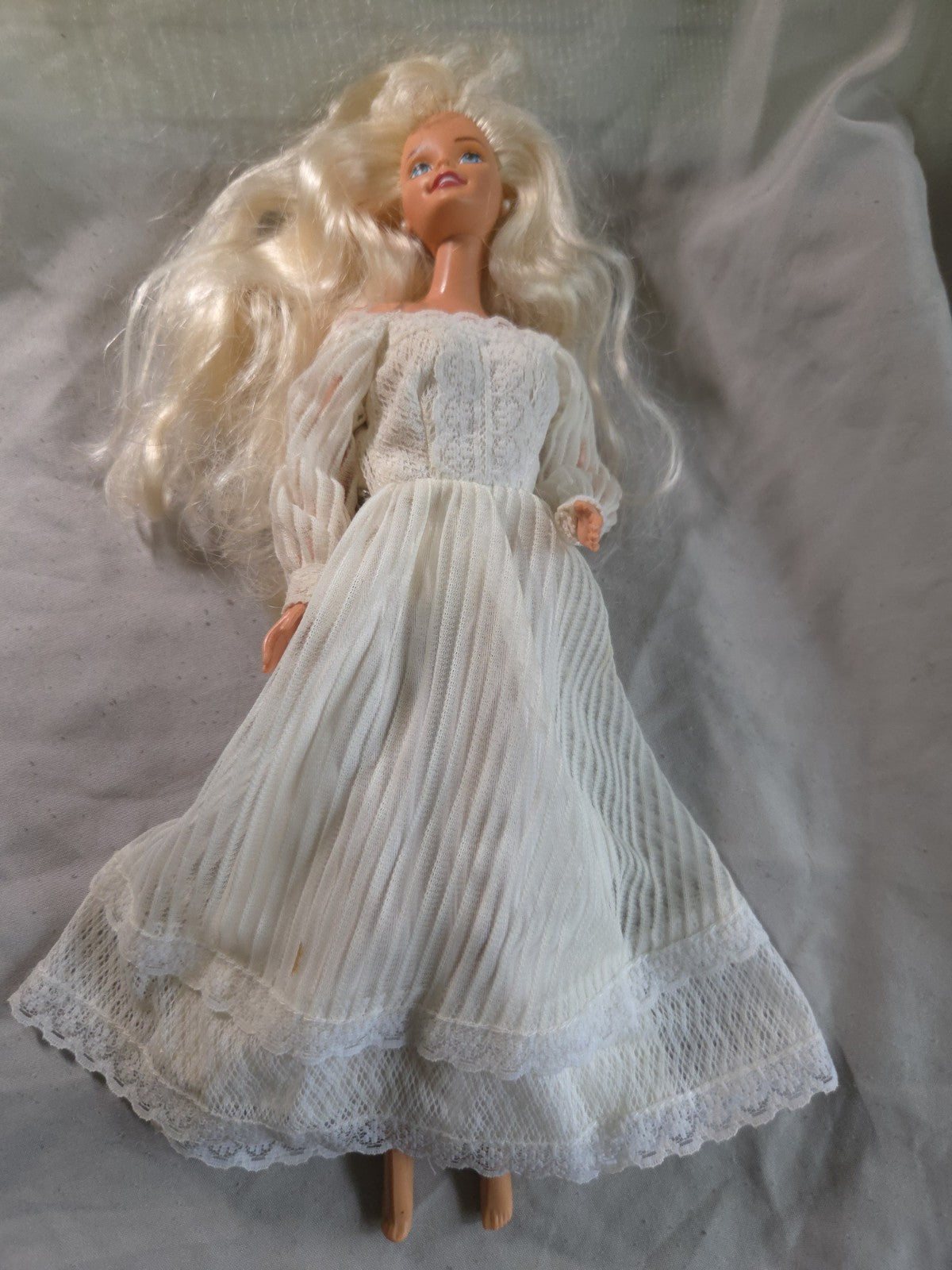 Mattel Barbie doll wearing a white pleated vintage wedding dress